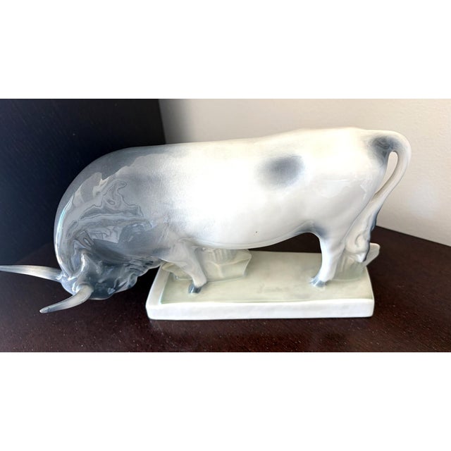 A striking mid-century Hungarian porcelain bull by Zsolnay Pécs, attributed to sculptor András Sinkó. The animal is caught...