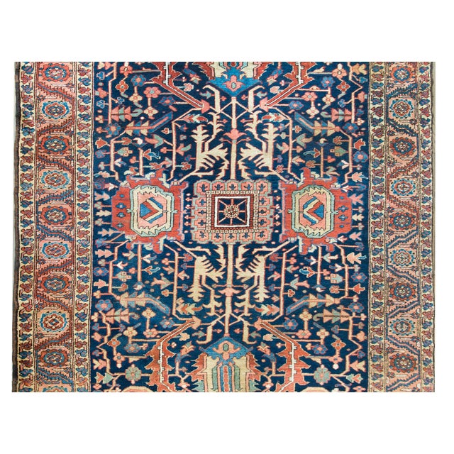 A rare and gorgeous early 20th century Persian Heriz rug with an unusual pattern containing two different large-scale...