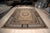 Vintage Aubusson in the Neoclassical style. A round compass medallion of cream and black panels sits on a camel field of...