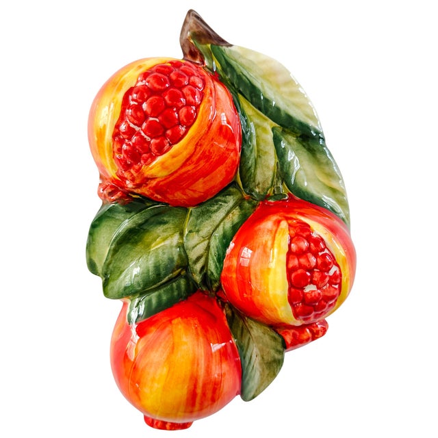 A striking pair of high-relief Italian ceramic wall plaques features bursting, hand-painted pomegranates—the traditional...