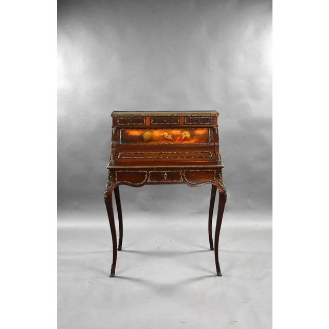 This is a good quality antique French style writing table by S&H Jewell, having ornate brass mounts throughout, the desk...