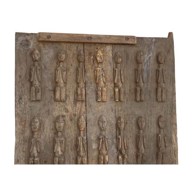 This rare Dogon granary door from Mali is a striking statement piece rich with ancestral significance. Standing ace. Hand-...