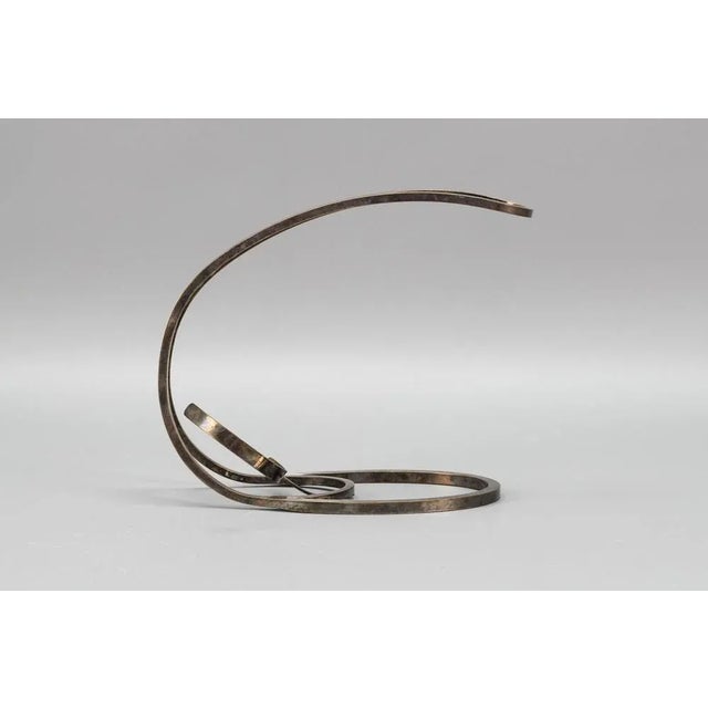 An elegant French Art Deco style bottle holder cradle. This beautiful bottle holder is made of silvered brass in circa...