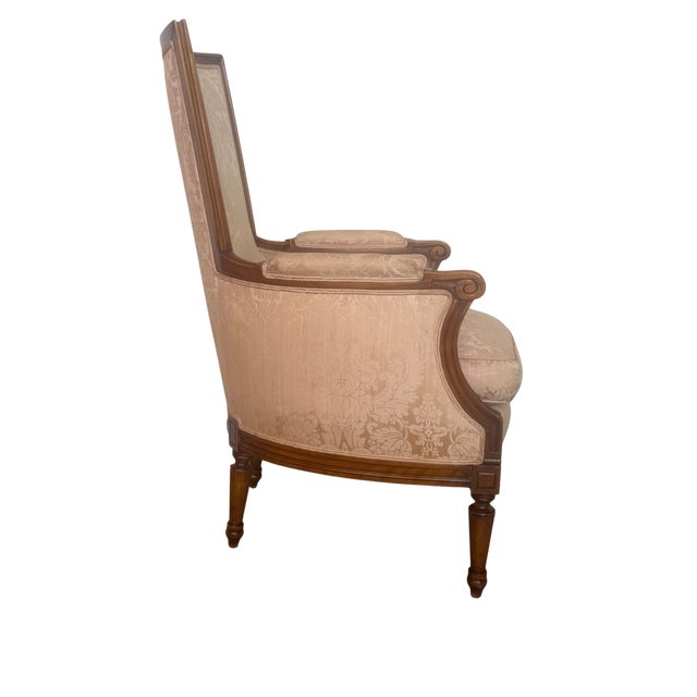 This is a beautiful custom upholstered bergere-style Barrell lounge chairs featuring graceful high back, sculptural walnut...