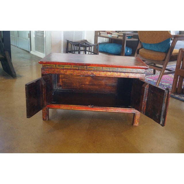 An old Tibetan altar / shrine table which is made of wood and hand painted. This beautiful piece opens with two doors at...