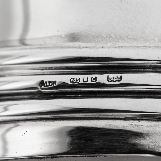 Modern 21st century english solid silver and glass wine decanter. The round, bulbous glass body features an extended...