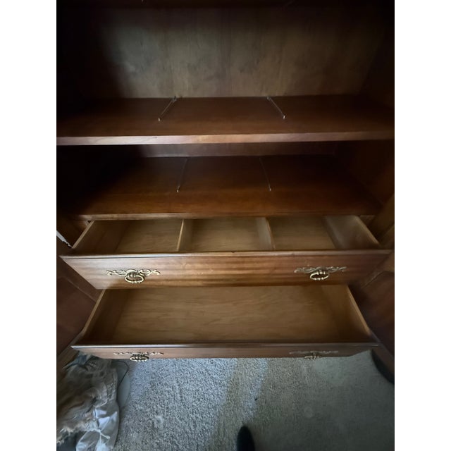 Offering a beautiful French Provincial armoire by Drexel Heritage. The armoire features nice carved and painted details....