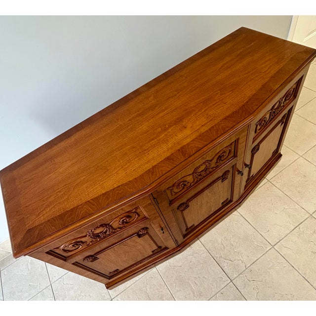 Walnut three door buffet/credenza cabinet with three drawers, a felt silverware coverlet and two spacious storage cabinets...