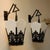 Pair of Asian-style black iron lanterns with metal cutwork and angular milk glass panels from the 1940s. Decorative...