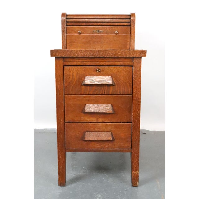This oak cabinet was designed for businesses to manage financial records and registers. The distinctive upper section...