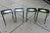 A set of four black metal folding TV dinner tray tables with floral hand painted motif.