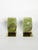 An elegant pair of bookends featuring blocks of natural green onyx set on polished brass bases. The mineral's magnificent...