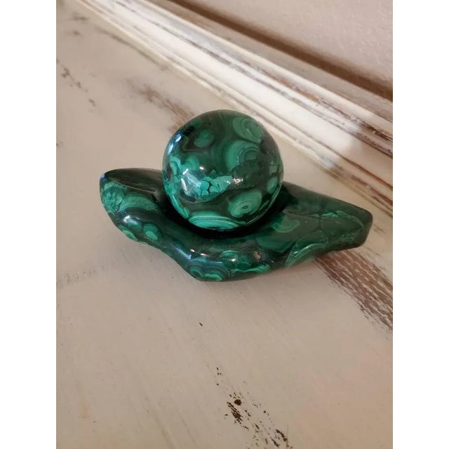 A beautiful, solid, hand carved and partially polished green malachite decorative stone/object/sculpture with a spherical...