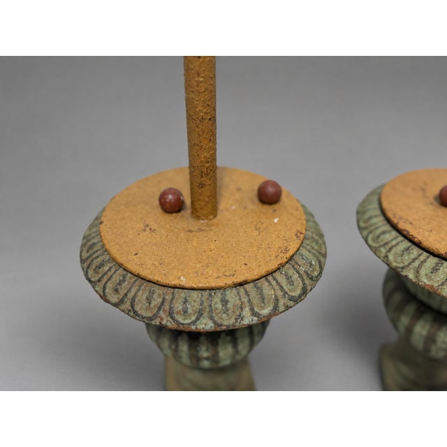 Pair of painted tole metal palm-form candlesticks, unmarked, likely mid-20th century and in the Italian or Continental...