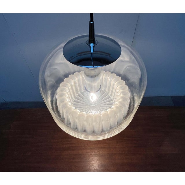 An impressive glass pendant lamp by the renowned manufacturer Peill & Putzler. The design showcases an organic form. Its...