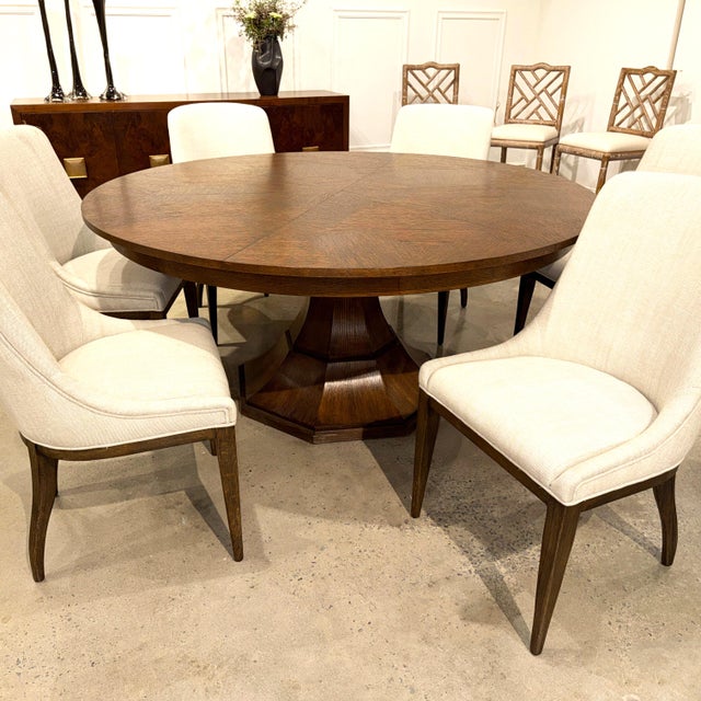 Narrow, angled strips radiate from the center of the top in a geometric wood pattern. The effect is quiet. Warm brown oak...