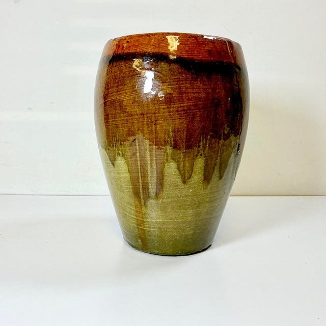 A gorgeous drip glazed hand-thrown studio pottery tall planter. The base color is olive green the drip colors are a...
