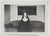 1950's venacular snapshot photograph of a nun seated on a sofa. Unframed.
