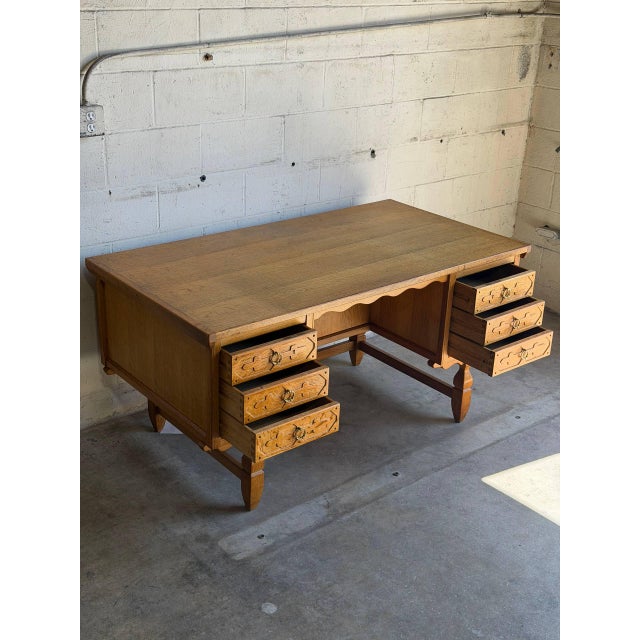Twin pedestals feature carved drawers on one side while the back reveals open nooks and a drop-front bar cabinet. Sculpted...