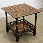 A wooden English coffee or end table has been recently updated with new paint of ebonized effect and pasted découpage...