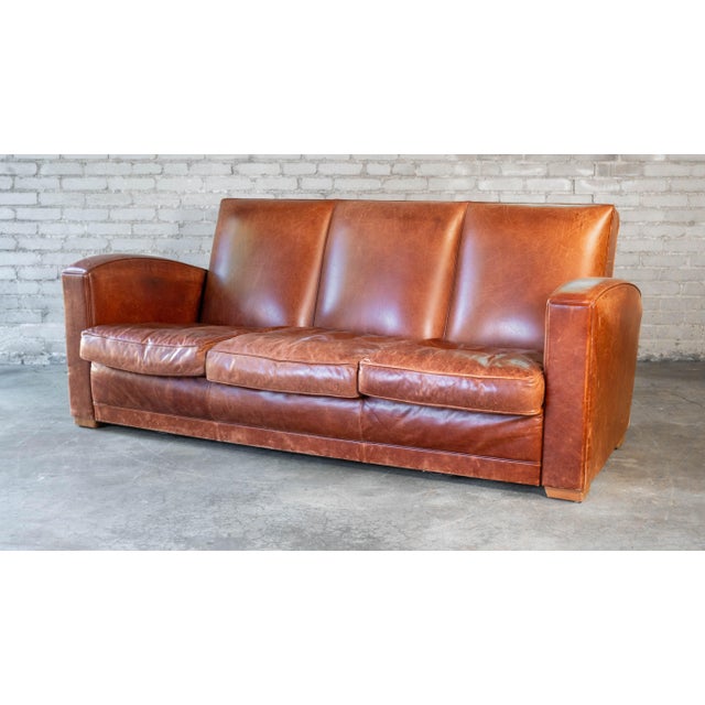 Vintage Art Deco distressed cognac leather three-seater sofa, circa 1970s. Lovely distressed cognac amber leather, showing...