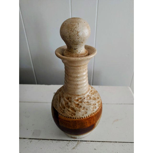 Here's a nice example of Leon Kula (1939-2012) pottery from the 1970s. It's heavy with wonderful earth tone colors. A...