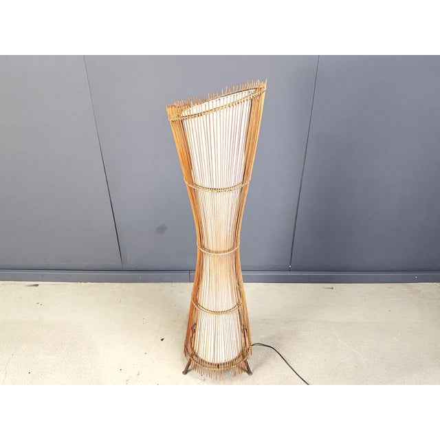 Mid century floor lamp in bamboo after Franco Albini. Beautiful shaped bamboo frame with a inner fabric lamp shade...