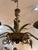 An elegant, six light Italian tole chandelier in a bronze and patinated gold paint finish. The hand-wrought fixture is...
