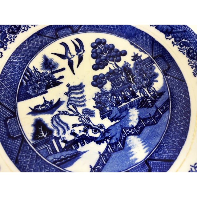 Classic English porcelain plate in the Willow pattern from the early 1900's. It's decorated with a Chinoiserie design and...