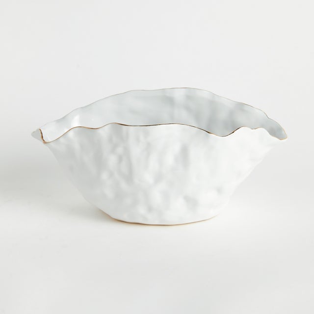 With crimped edges and natural form, this wide vase is a real statement-making centerpiece. The hand-brushed gold tipped...