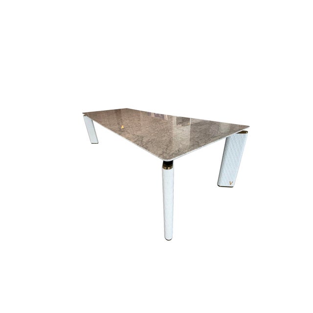 This stunning V-Marble Table from Versace Home blends modern luxury with exceptional craftsmanship. Featuring a top of...