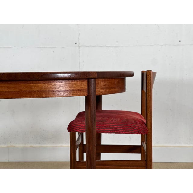 Elevate your dining space with this exquisite circular dining table, designed by Viktor Wilkins and meticulously...