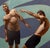 6 and Two by Zack Zdrale | Oil on Panel Male figures in dynamic poses against a blue background. For Sale