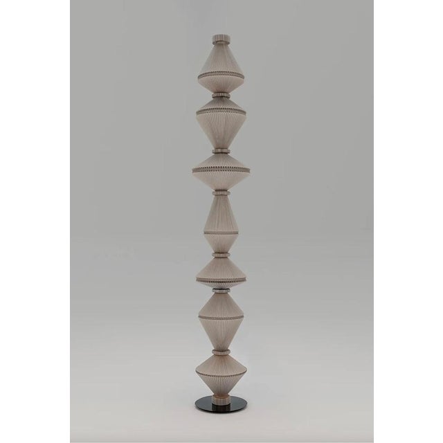 Atelier oï oïphorique p gr still floor lamp for parachilna floor lamp providing ambient light composed of a steel base...