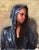 The artwork features a figure draped in a shimmering, sequined hoodie, casting a contemplative gaze. The play of light on...