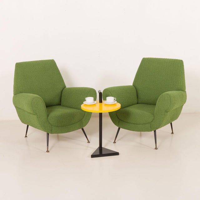 A pair of italian lounge chairs designed most likely by gigi radice and made by minotti in the 1960s. These armchairs,...