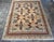 This vintage Lahore rug features a refined geometric medallion composition rendered in a warm, balanced palette of ivory,...