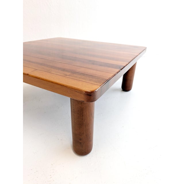 Vintage Italian walnut coffee table from the late 1960s featuring a square wooden top with a beautiful striped wood inlay...