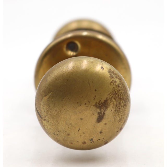 Classic style polished brass passage door knob set. Priced as two hollow door knobs, two rosettes, and a spindle. The...