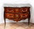 Antique French Louis XV chest of drawers crafted from fine exotic woods, featuring a marble top and gilded bronze...