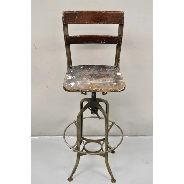 industrial Toledo Metal Co Steel and Wooden Adjustable Drafting Stool. Circa Early 20th Century. Measurements: 44" H x...