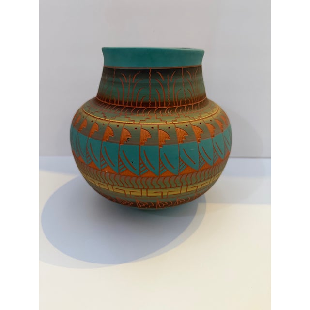Handcrafted Navajo art pottery vase signed by artisan Davis Willie. This striking vessel features an elegant rounded form...