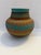 Handcrafted Navajo art pottery vase signed by artisan Davis Willie. This striking vessel features an elegant rounded form...
