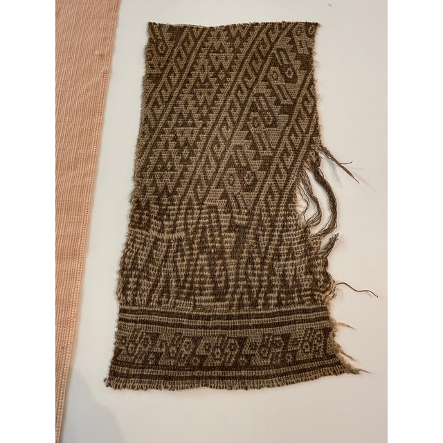 Handwoven textiles from Southeast Asia. This particular textile fragment showcases a complex geometric design. Such pieces...