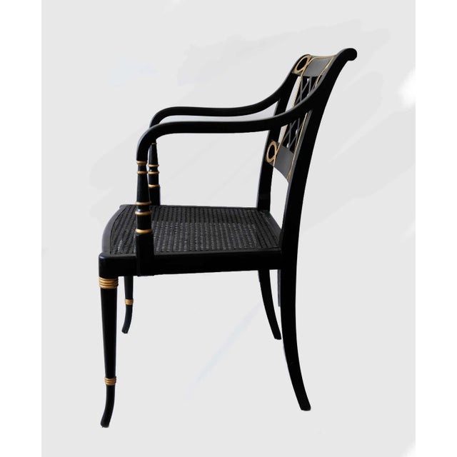 Vintage, ebonized, and parcel-gilt bench and armchair in the Regency or Sheraton style. Intricate latticework back panels...