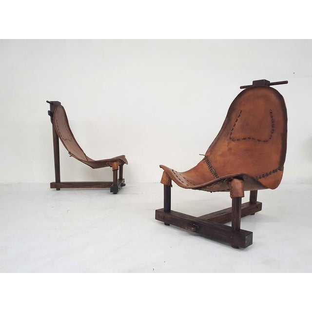 Solid wooden frames and saddle leather seating.