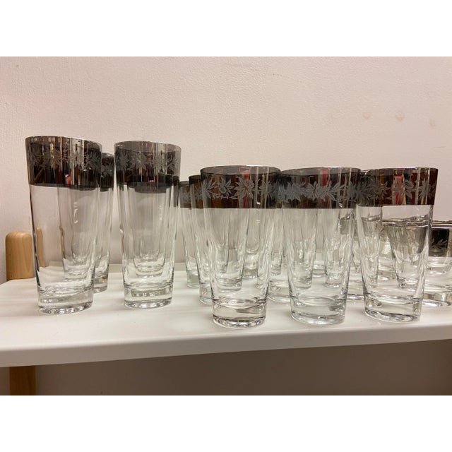 Mid-Century Dorothy Thorpe style silver rim glasses with embossed flower motif. Includes 6 highball tumblers, 13 water...