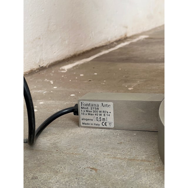 Pirellone is a floor lamp with a molded and curved glass diffuser and a satin nickel-plated brass frame. The dimmer on the...