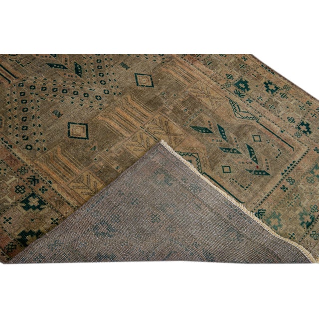 Beautiful Vintage Geometric hand-knotted wool rug with a brown field. This rug has black and tan accents all-over a...