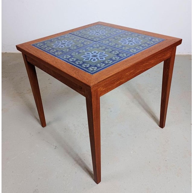 1970s Danish side table with Skærbæk flower decorated tiles in very good condition The side table has been restored and...